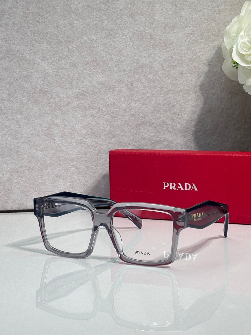 Prada rectangular eyeglasses with translucent light frames and clear lenses