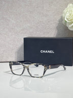 Gray-tortoise eyeglasses with square lenses, CHANEL logo on side, full frame.