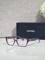 Purple and dark eyeglasses frame with square lenses and CHANEL logo on temple.