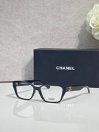 Dark navy eyeglasses with rectangular lenses and CHANEL logo at temple, full frame.