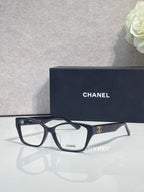Chanel eyeglasses with dark frames, clear lenses, leopard temple details
