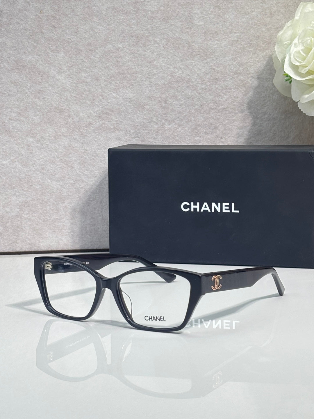 Chanel eyeglasses with dark frames, clear lenses, leopard temple details