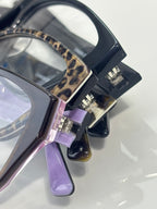 Chanel eyeglasses hinge detail with dark frame, leopard inlay, and purple temple