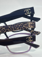 Chanel eyeglasses with dark frames, leopard-print temples, CC-logo detailing