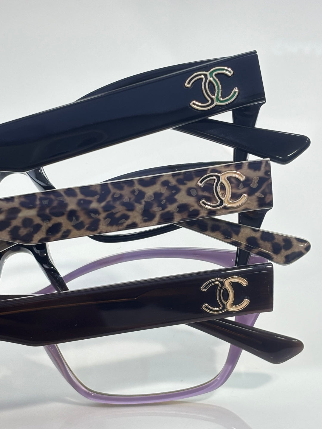 Chanel eyeglasses with dark frames, leopard-print temples, CC-logo detailing