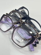 Chanel eyeglasses with dark frames, leopard-print temples, purple-tinted lenses