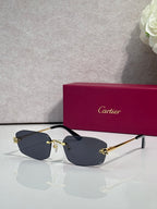 Cartier sunglasses with gold frame, dark navy lenses, black temple tips