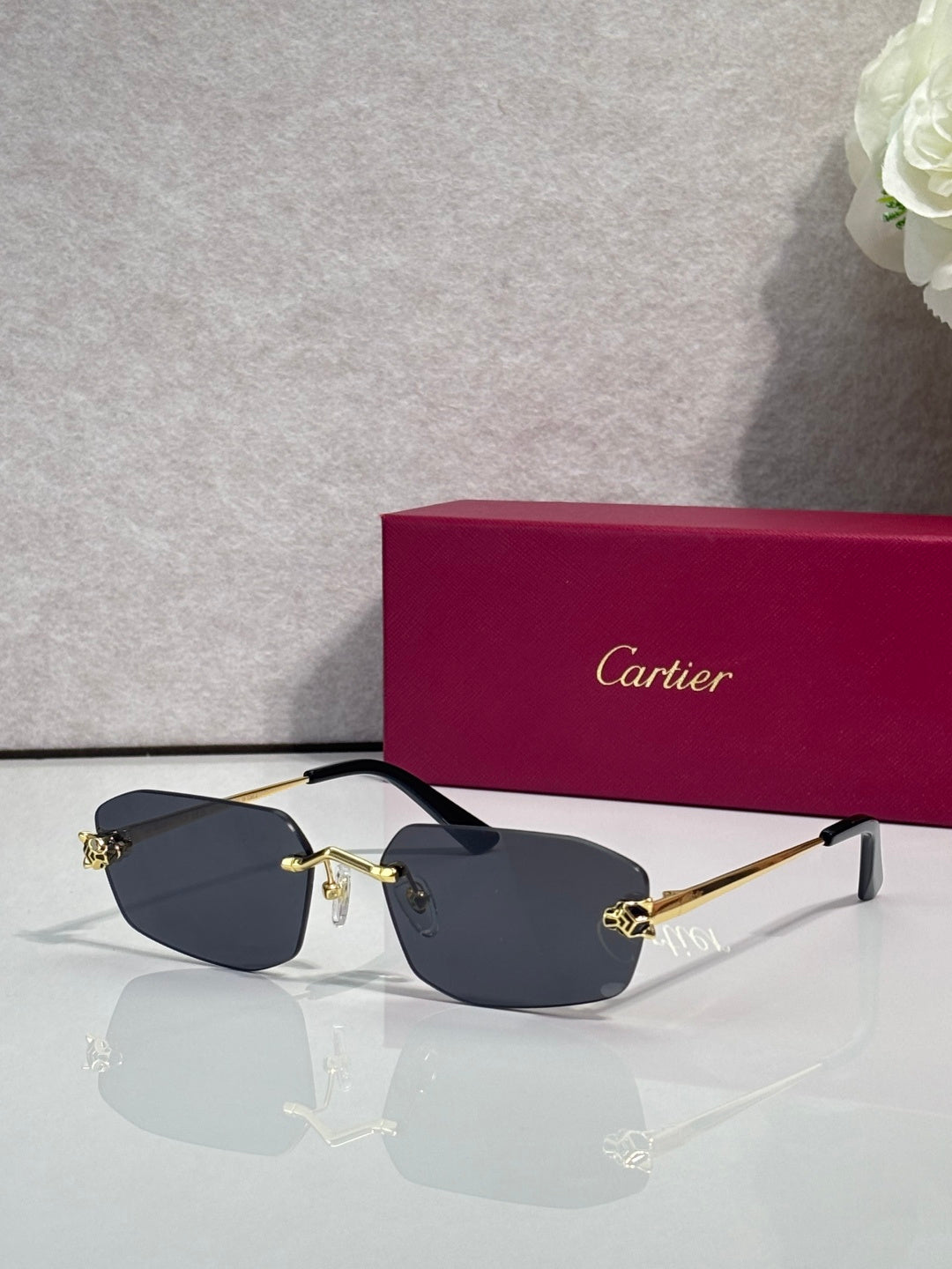 Cartier sunglasses with gold frame, dark navy lenses, black temple tips