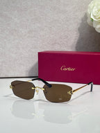 Cartier sunglasses with gold frame, dark brown lenses, black temple tips