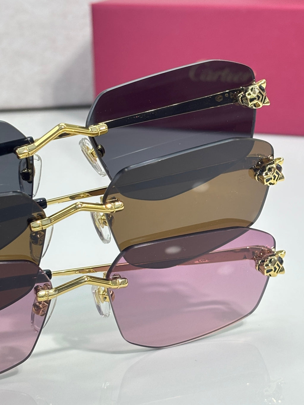 Cartier sunglasses close-up of gold frame tips with multiple colored lenses