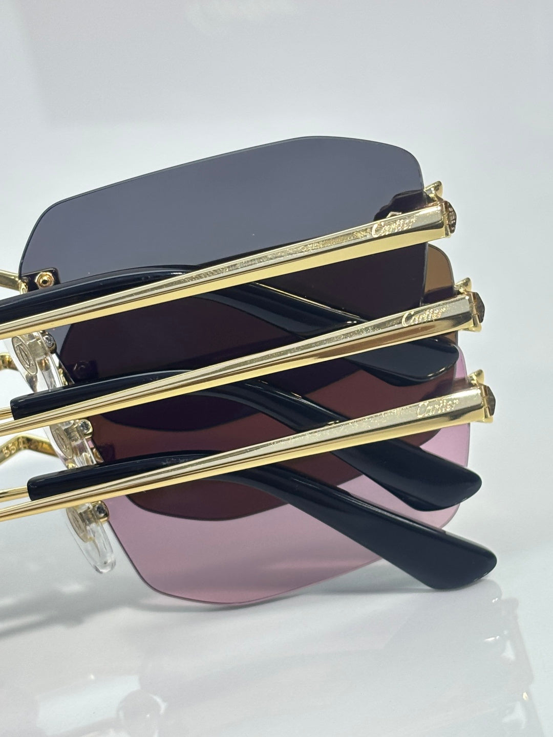 Cartier sunglasses side close-up with gold arms and layered colored lenses