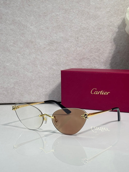 Cartier glasses with gold frame, dark brown lenses, and black temples