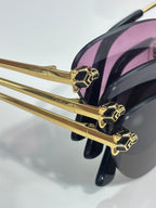 Cartier glasses close-up: gold frame with pink-tinted lenses and geometric studs