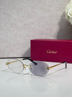 Cartier round sunglasses with clear frames, gold temples, gray tint lenses