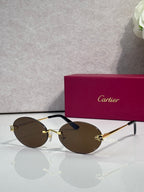 Cartier round sunglasses with clear frames, gold temples, brown tint lenses