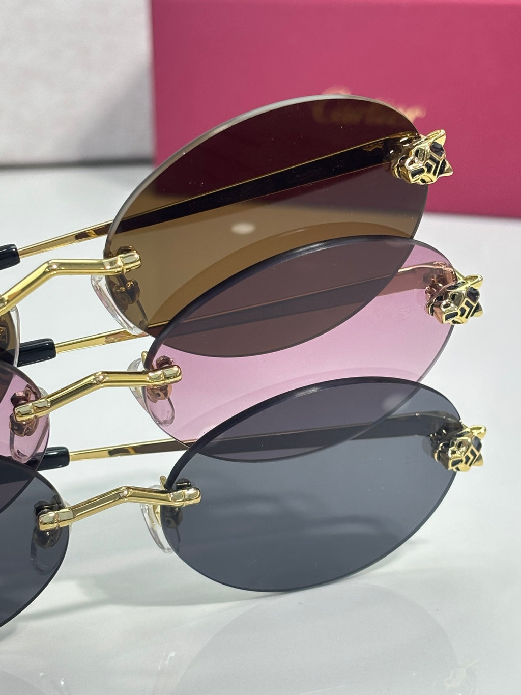 Cartier round sunglasses close-up: stacked colored lenses with gold details