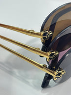 Cartier round sunglasses close-up: gold temple hinge with dark lenses