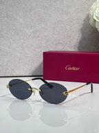 Cartier round sunglasses with clear frames, gold temples, navy tint lenses