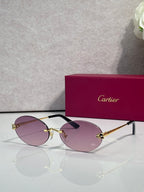 Cartier round sunglasses with clear frames, gold temples, purple tint lenses