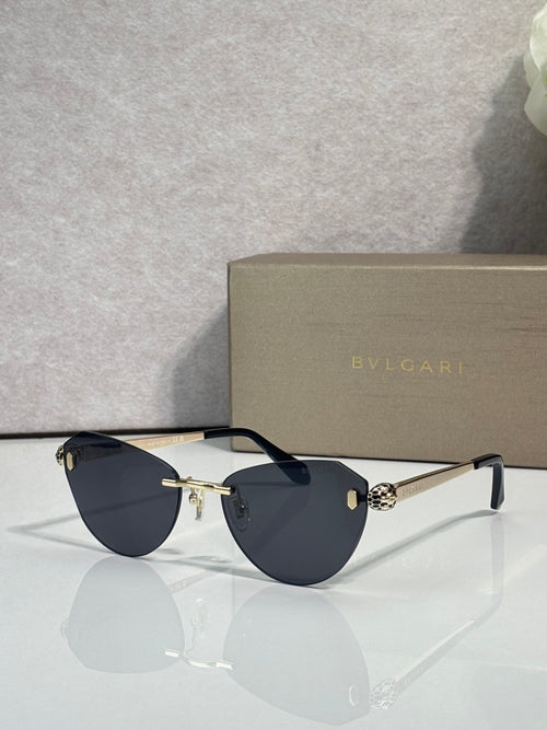 Sunglasses with dark blue lenses, slim black frame, and gold bridge hardware