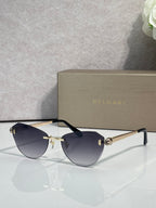 Sunglasses with dark blue tinted lenses, black frame, and gold metal arms