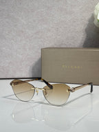 Sunglasses with amber tinted lenses, black frame, and gold metal accents