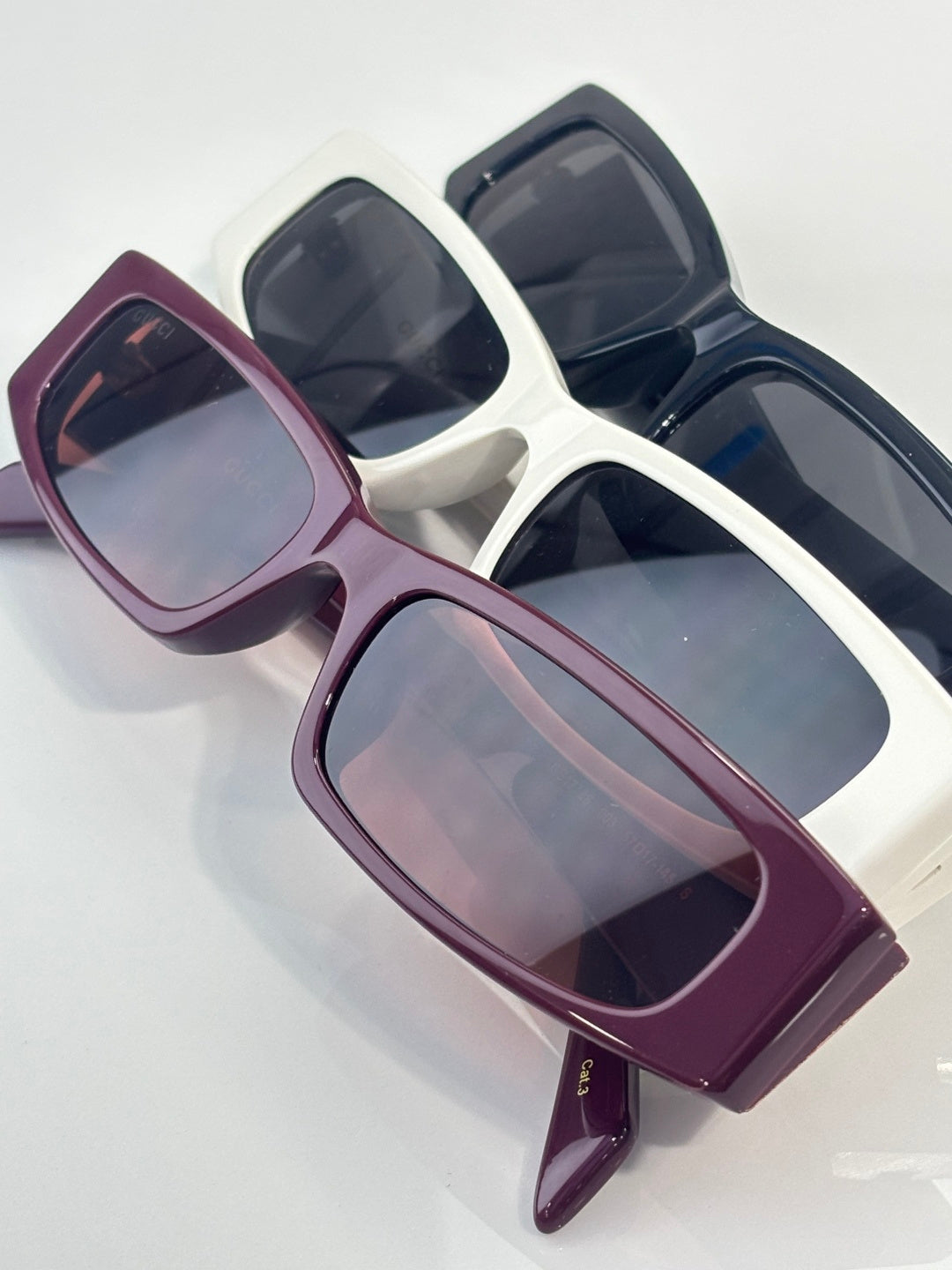 Gucci sunglasses with burgundy frames and light-pink tinted lenses
