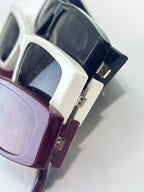 Gucci sunglasses close-up with white frame and dark tinted lenses