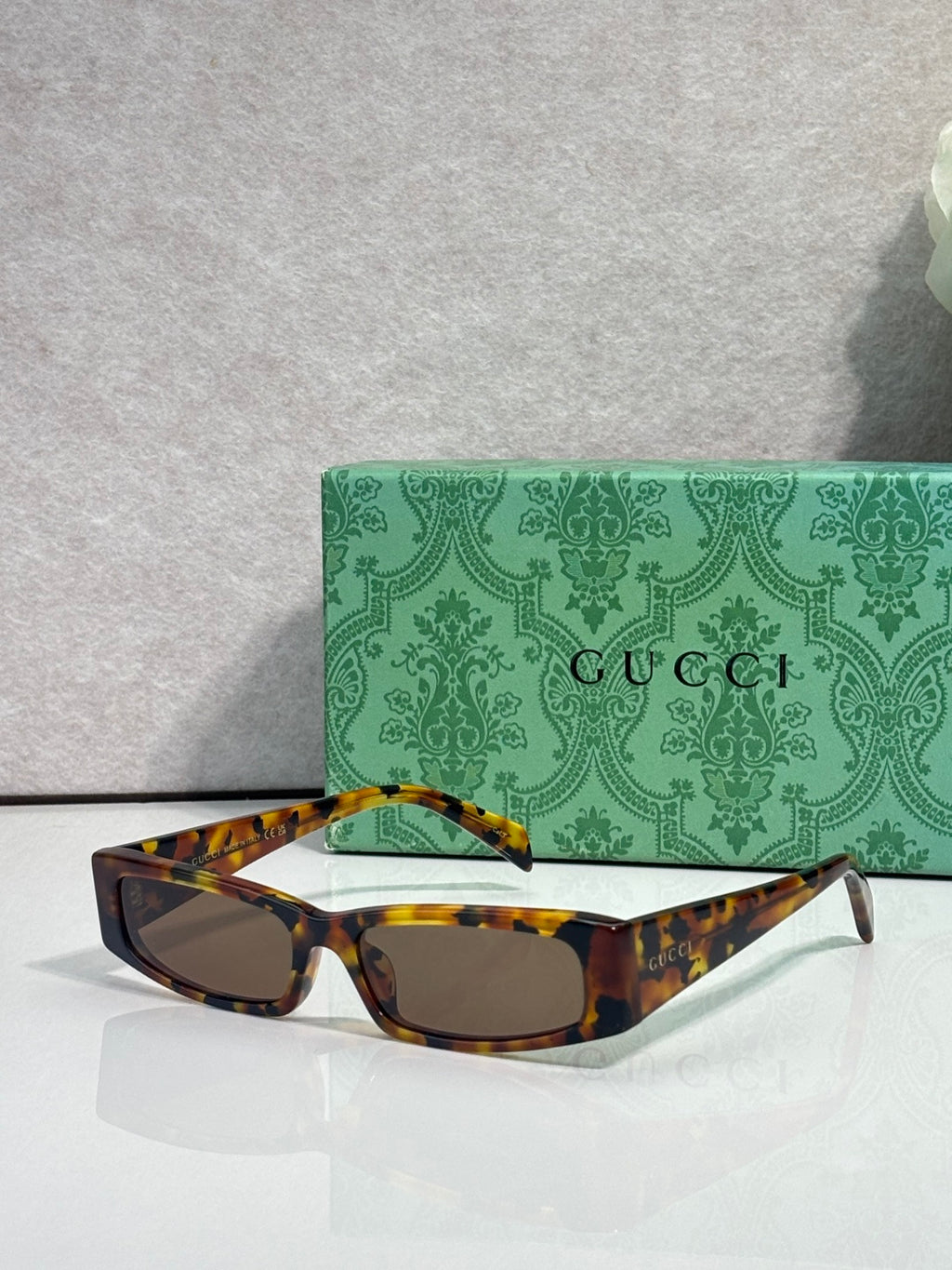 Gucci sunglasses with tortoise frames and dark tinted lenses