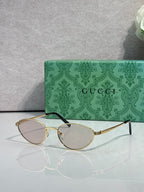 Gucci sunglasses with gold-tone frame and clear lenses
