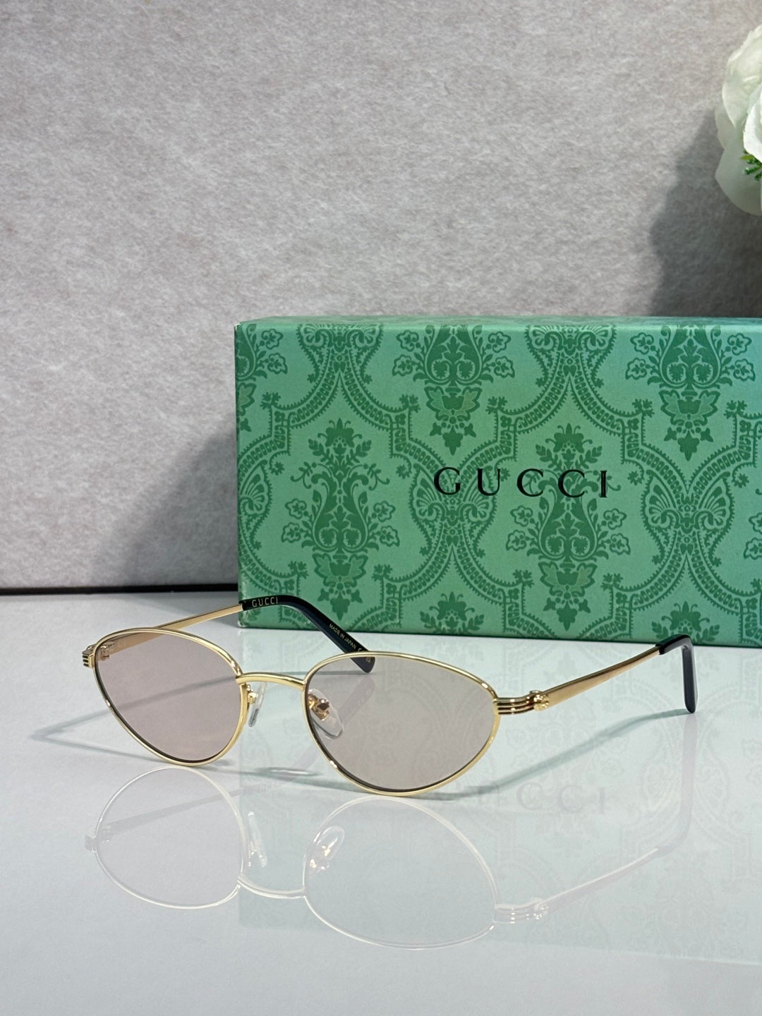 Gucci sunglasses with gold-tone frame and clear lenses