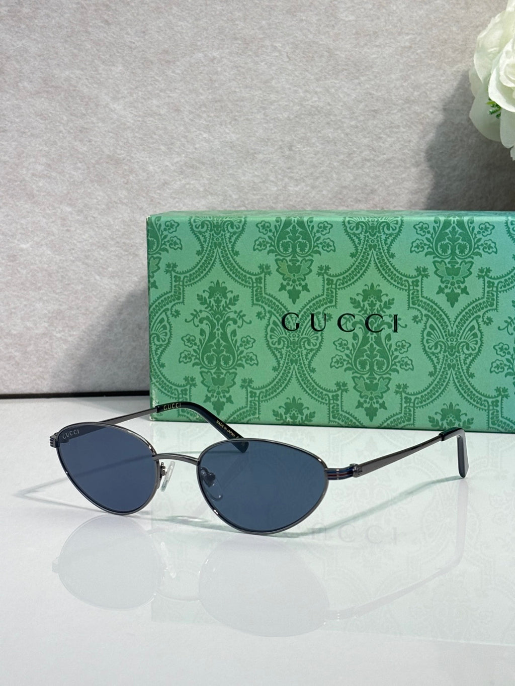 Gucci sunglasses with blue-dark lenses and silver-tone frame