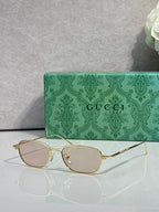 Gucci sunglasses with gold frame and light tinted lenses, oval shape