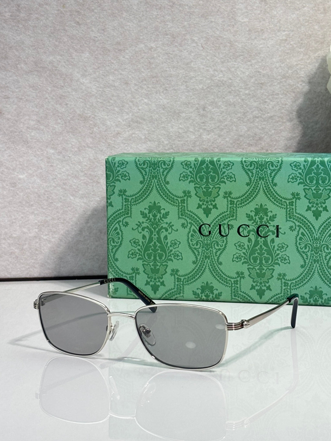 Gucci sunglasses, gray lenses in gold frame with black temples
