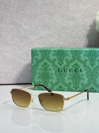 Sunglasses with gold frame and tinted yellow lenses, slim metal temples
