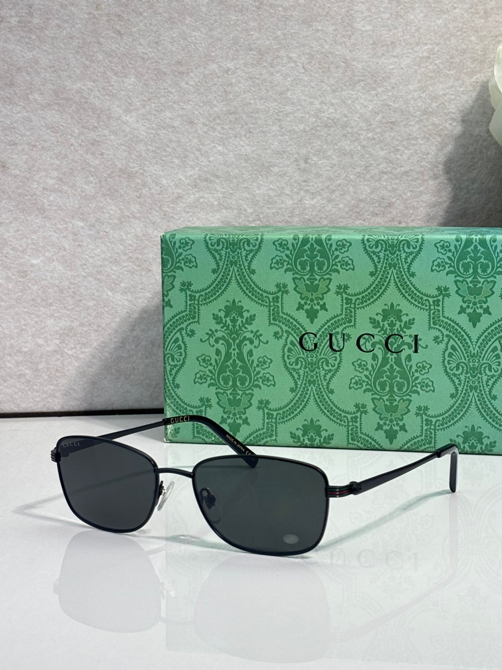 Sunglasses with dark lenses and black frame, straight metal temples