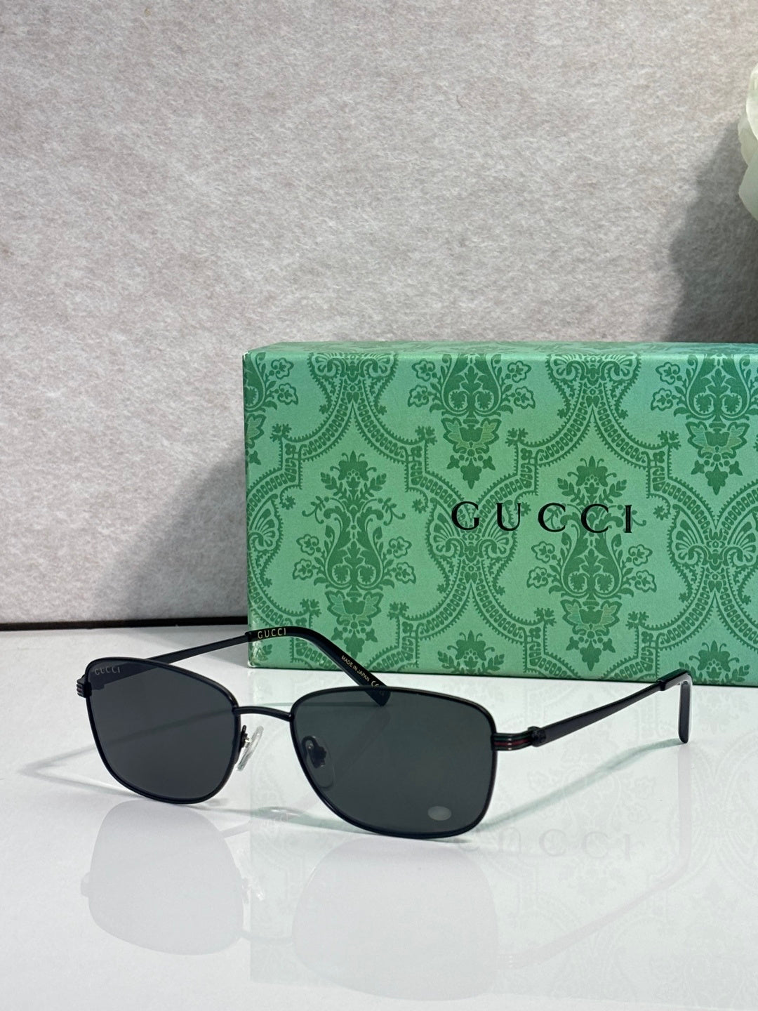 Sunglasses with dark lenses and black frame, straight metal temples