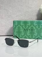 Sunglasses with dark lenses and silver-toned frame with black temple tips