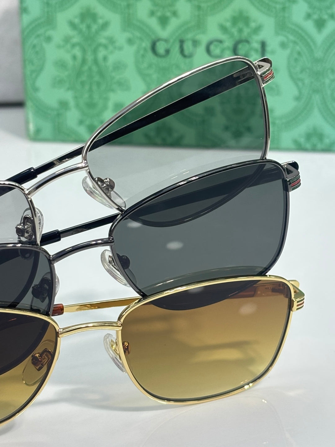 Sunglasses set with overlapping frames: dark and gold lenses, metal bridge detail