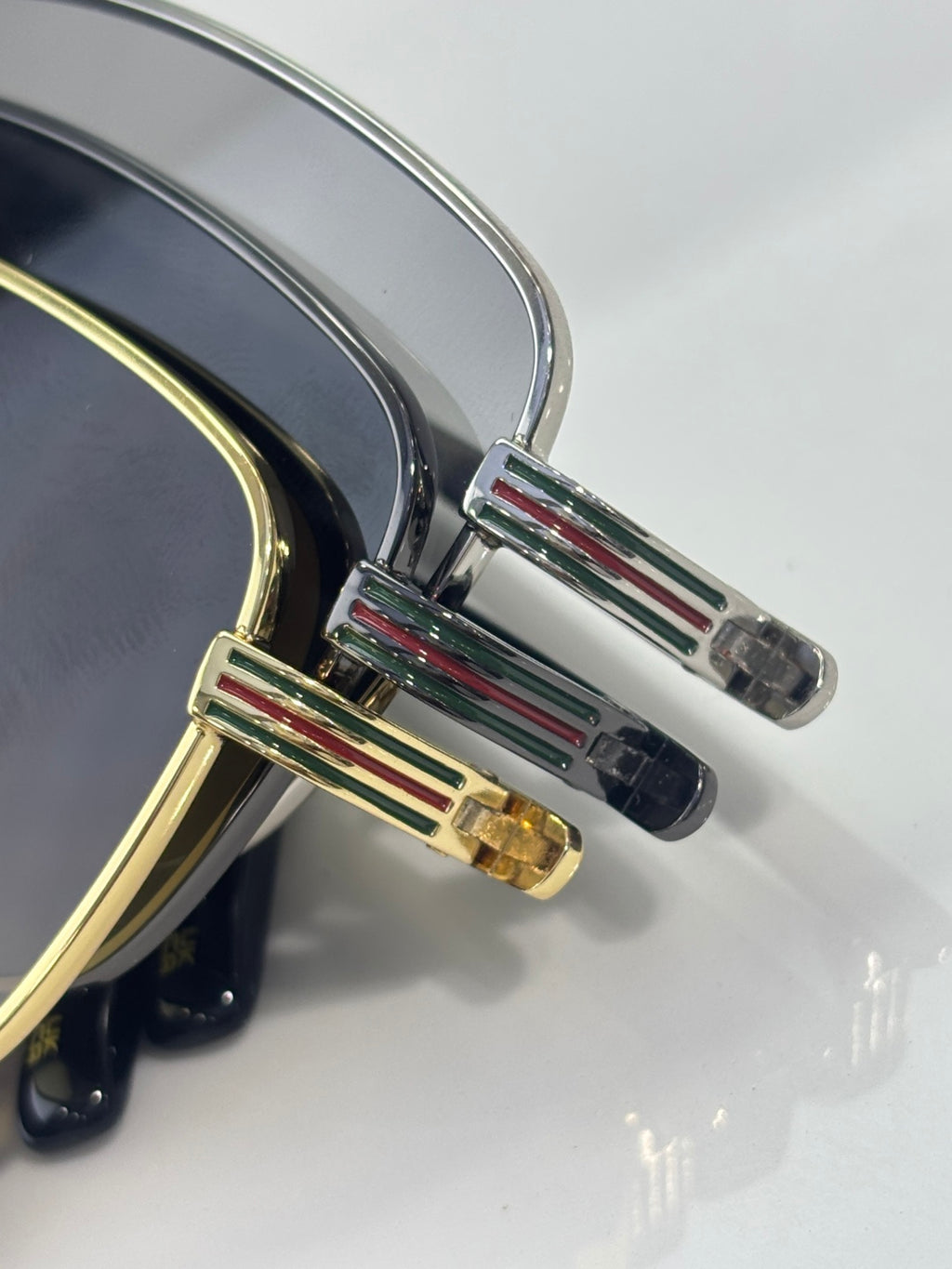 Sunglasses close-up of temple detail with multicolor striped accents and metal hinge
