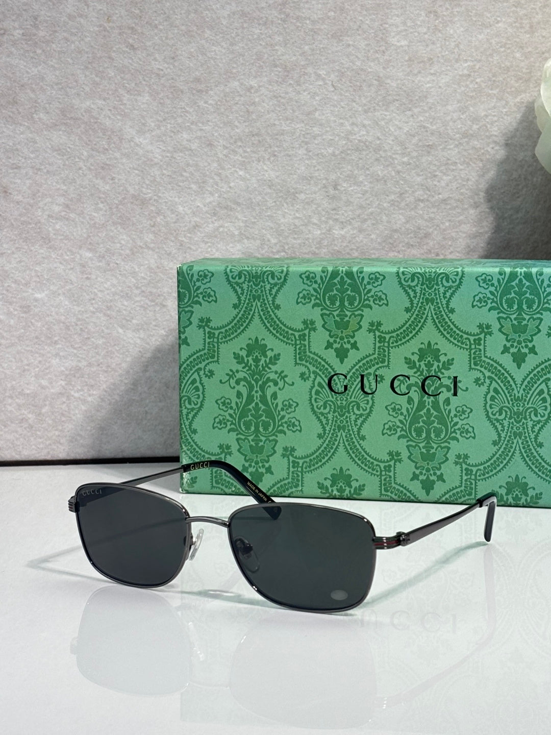 Sunglasses with dark lenses, black frame, and slim metal temple arms