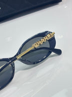 Chanel sunglasses with gold bar bridge detail and dark blue frame