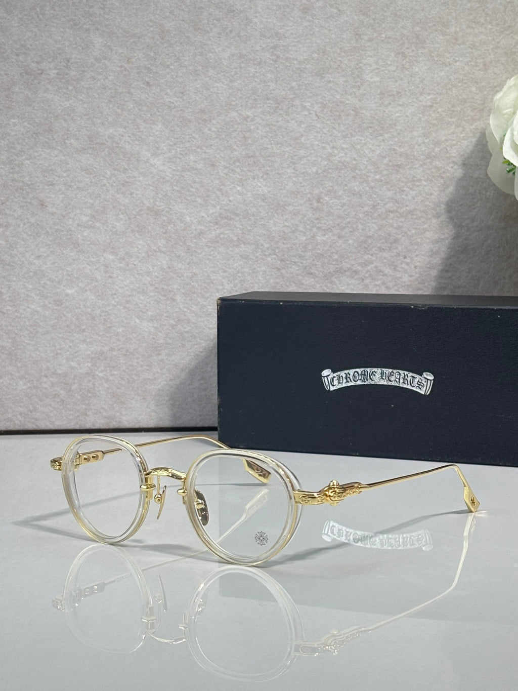 Chrome-finish round eyeglasses with gold metal frames and clear lenses