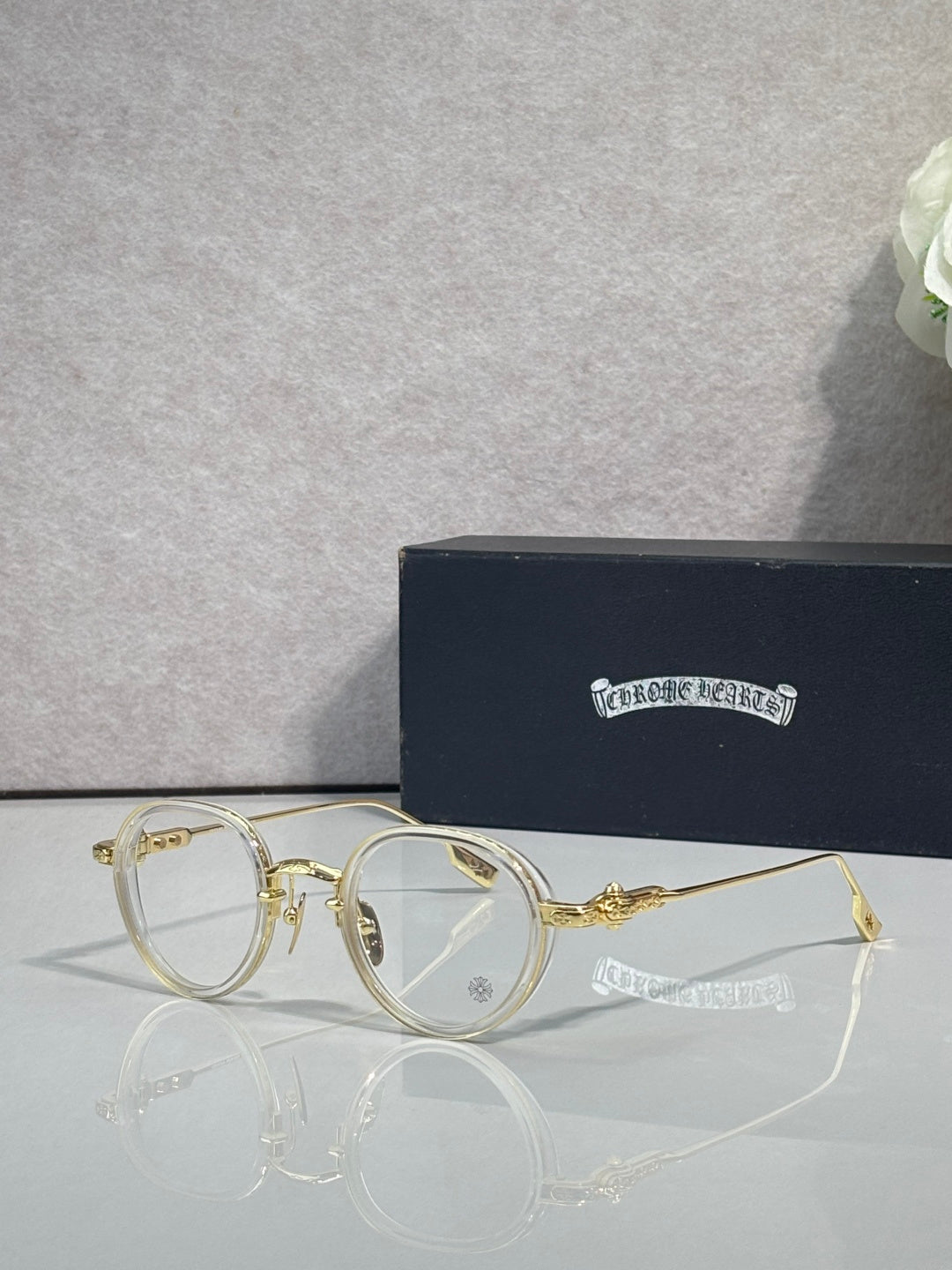 Chrome-finish round eyeglasses with gold metal frames and clear lenses