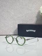 Chrome-finish round eyeglasses with green metal frames and clear lenses