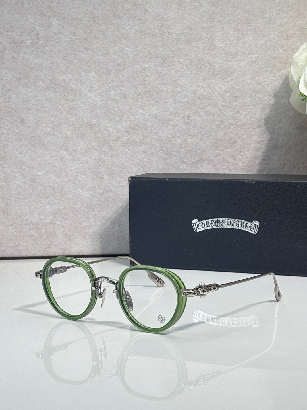 Chrome-finish round eyeglasses with green metal frames and clear lenses