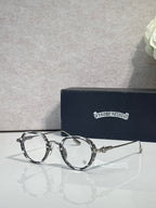 Chrome-finish round eyeglasses with dark metal frames and clear lenses