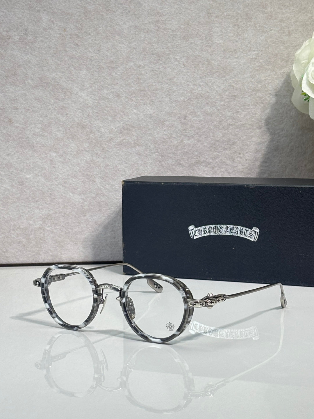 Chrome-finish round eyeglasses with dark metal frames and clear lenses