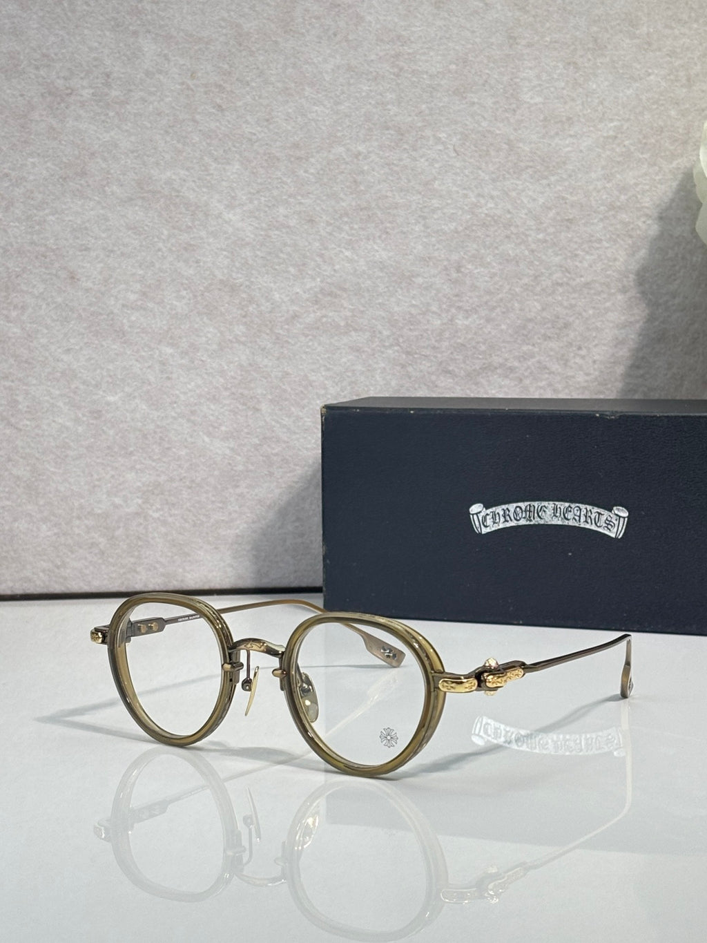 Chrome-finish round eyeglasses with tan/gold frames and clear lenses