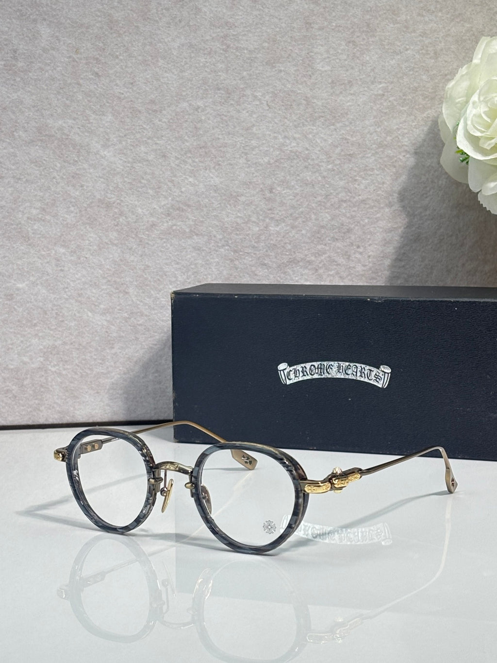 Chrome-finish round eyeglasses with dark frames and clear lenses
